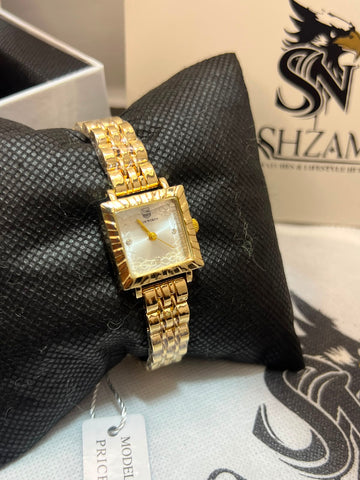 True Worth Ladies Gold Square Watch showing white floral dial with crystal markers and gold brick-link bracelet on black pillow