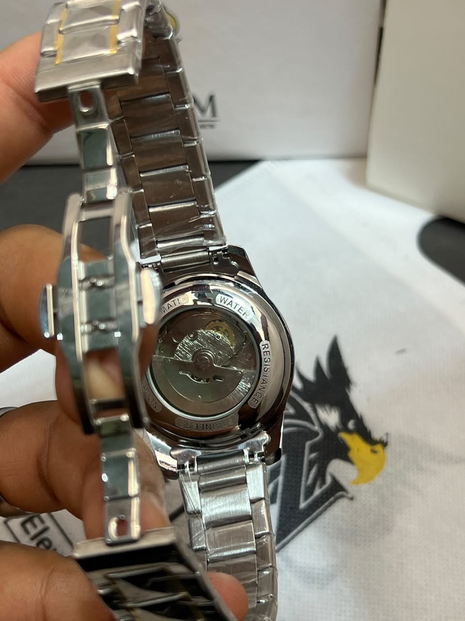 Tisselin Automatic Exhibition Case Back close-up with visible mechanical movement and gold crown