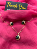 Emerald Green Square Crystal Halo Necklace and Earrings Set on red fabric