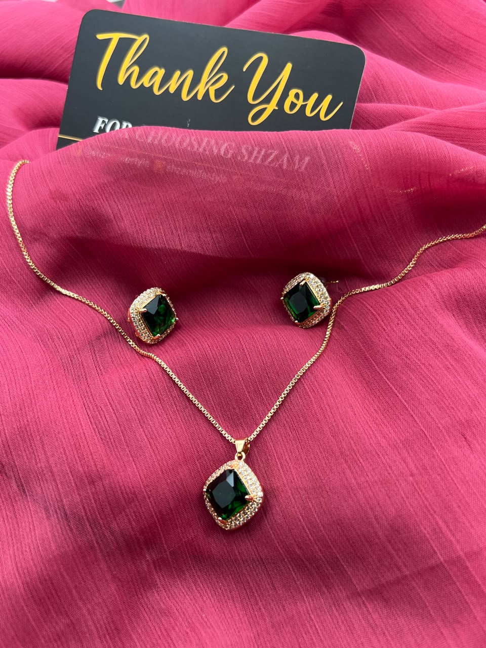 Emerald Green Square Crystal Halo Necklace and Earrings Set on red fabric