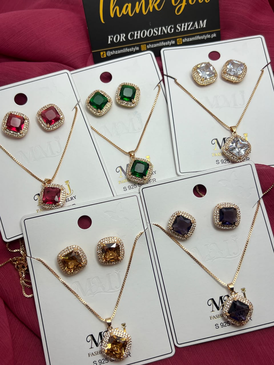 All 6 colors of Square Crystal Halo Necklace & Earrings Set displayed on cards with Shzam thank you card
