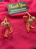 Single Gold Crystal Flower Cuff Bangle Ruby Red variant standing upright showing X-bar design