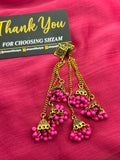 Hot Pink Magenta Antique Gold Tiered Jhumka Chandelier Earrings on pink fabric