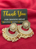 Pearl Chandbali Flower Earrings front view showing crystal flower top and pearl fringe on pink fabric