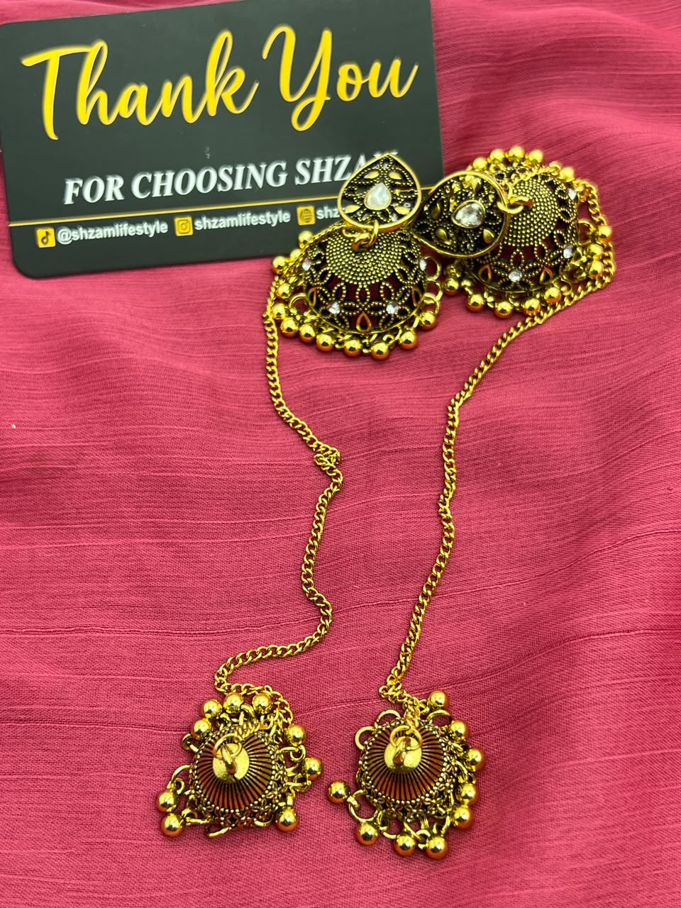 Antique Gold Jhumka Earrings with Chain and Tikka close-up showing dome and sunburst tikka detail