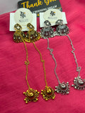 Antique Gold and Oxidized Silver Jhumka Earrings with Chain and Tikka both pairs on pink fabric with Shzam cards