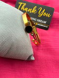 Gold bangle with black circle stone