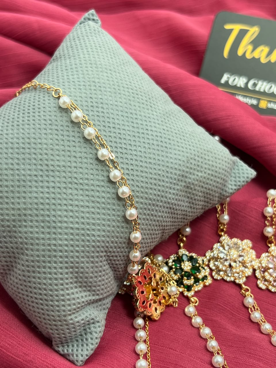 Pearl Crystal Flower Bracelets collection flat lay on red fabric